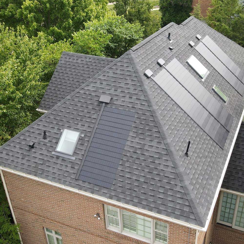 Aerial view of a home with solar shingles installed on the roof