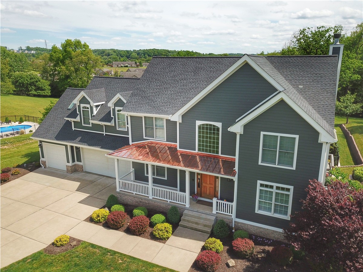 Completed exterior remodel, green two-story home